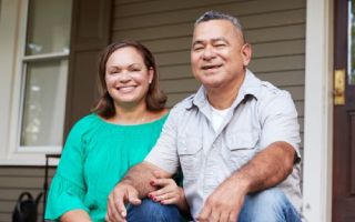 couple smiling sitting on porch